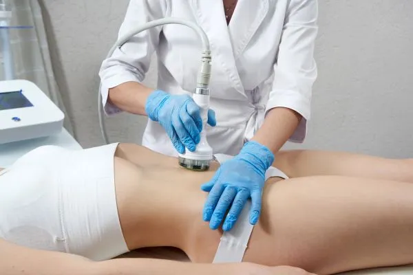 Lost the Weight but Not the Loose Skin? 2 woman having HIFU treatment on her stomach to combat loose skin Heanor following weight loss
